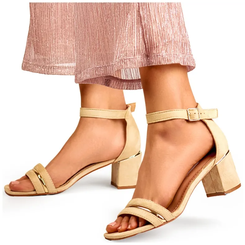 Beige women's low-heeled sandals with ankle fastening