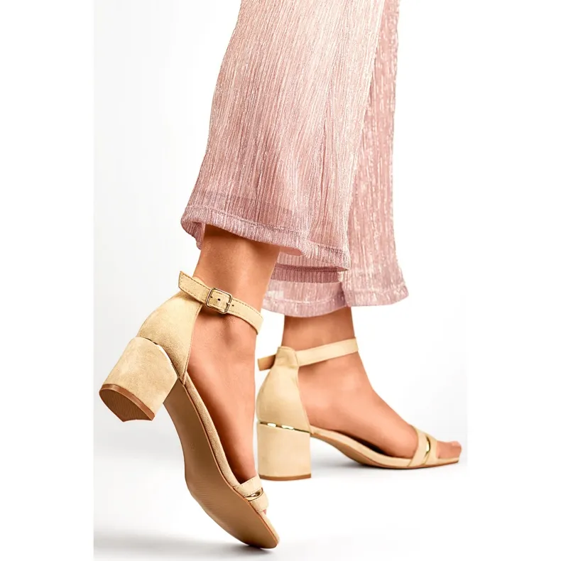 Beige women's low-heeled sandals with ankle fastening